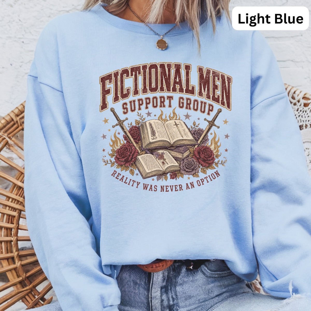 Light blue crewneck sweatshirt with "Fictional Men Support Group" graphic.