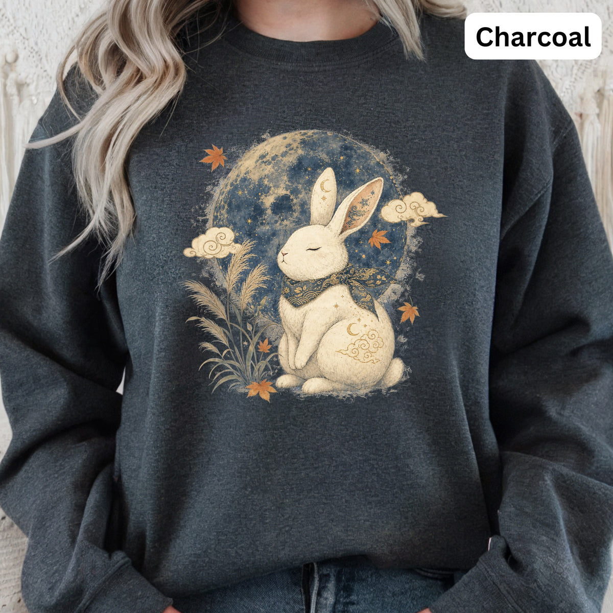 Charcoal sweatshirt with a white rabbit illustration and a moon in a starry night sky.