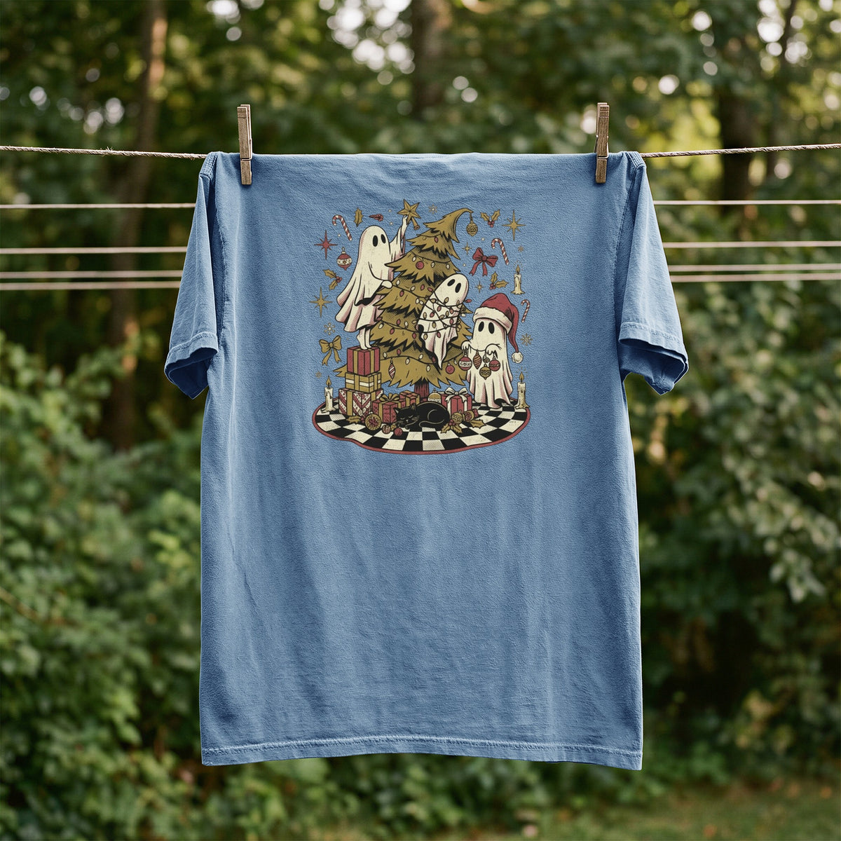 T-shirt with ghosts decorating a Christmas tree and surrounded by gifts.