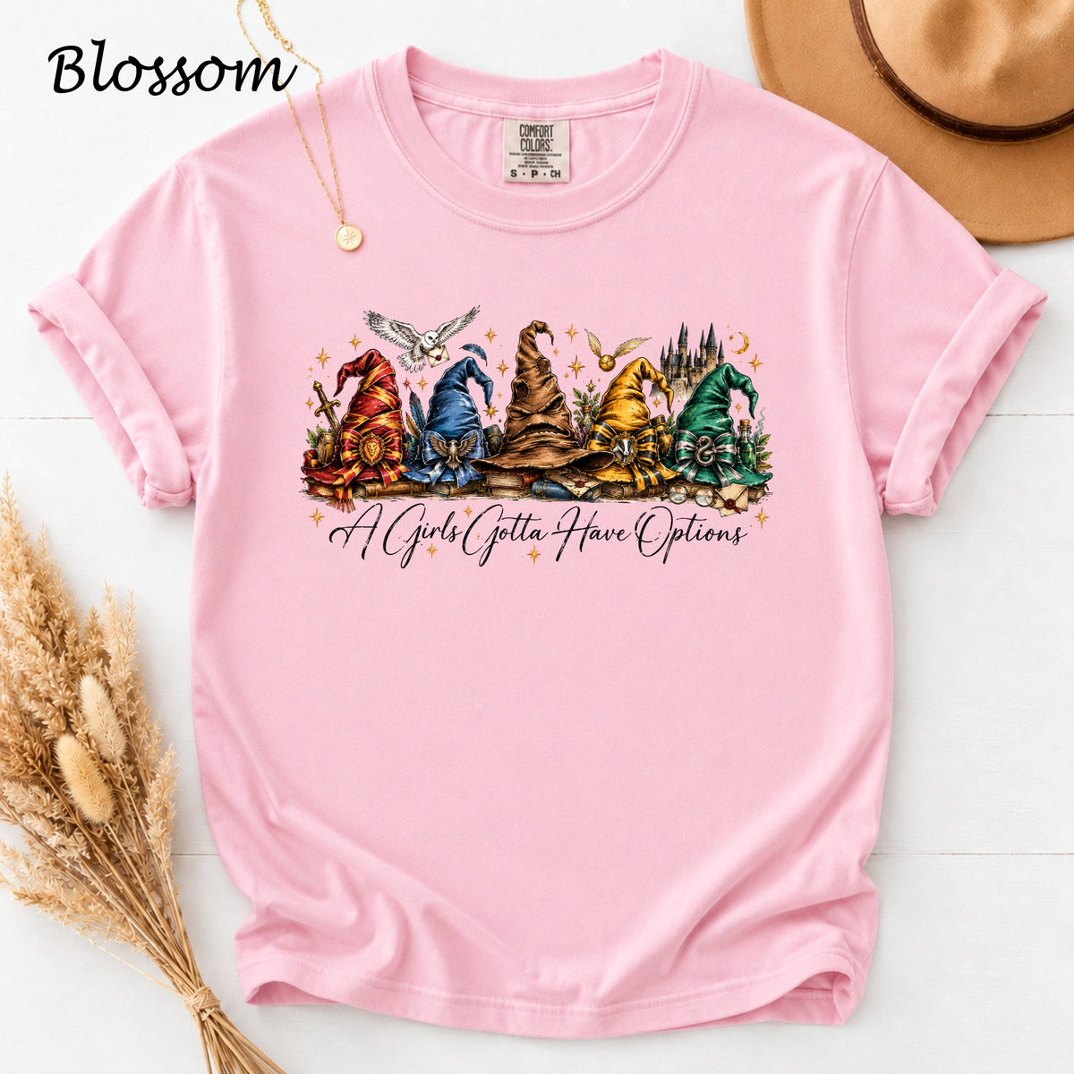 Pink t-shirt with wizard hats and text "A Girls Gotta Have Options".