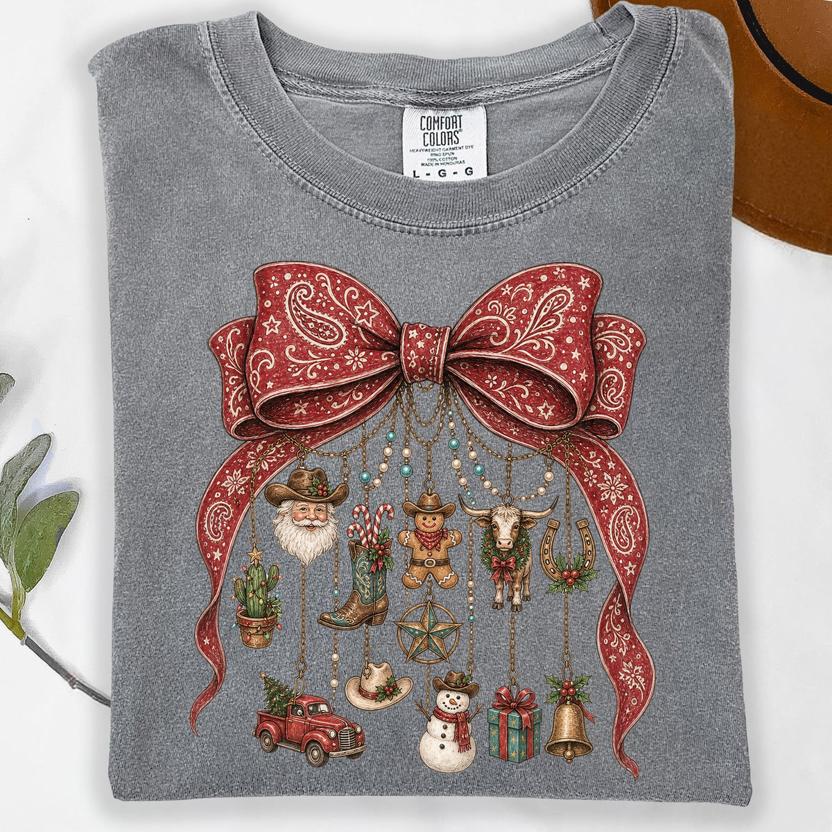 Gray t-shirt with red bandana print bow and western-themed Christmas ornaments.