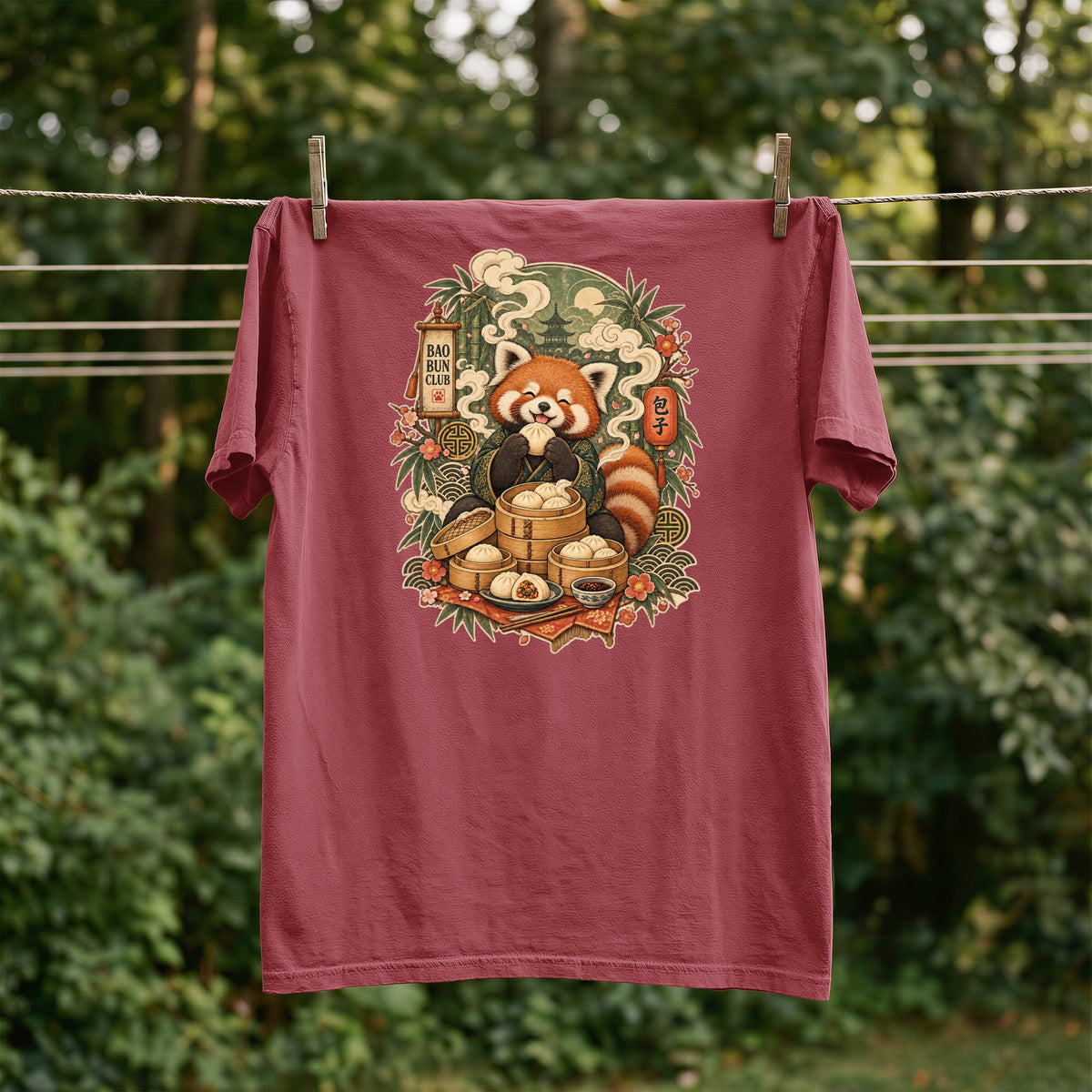 Red panda eating dumplings with "Bao Bun Club" text on a maroon t-shirt.