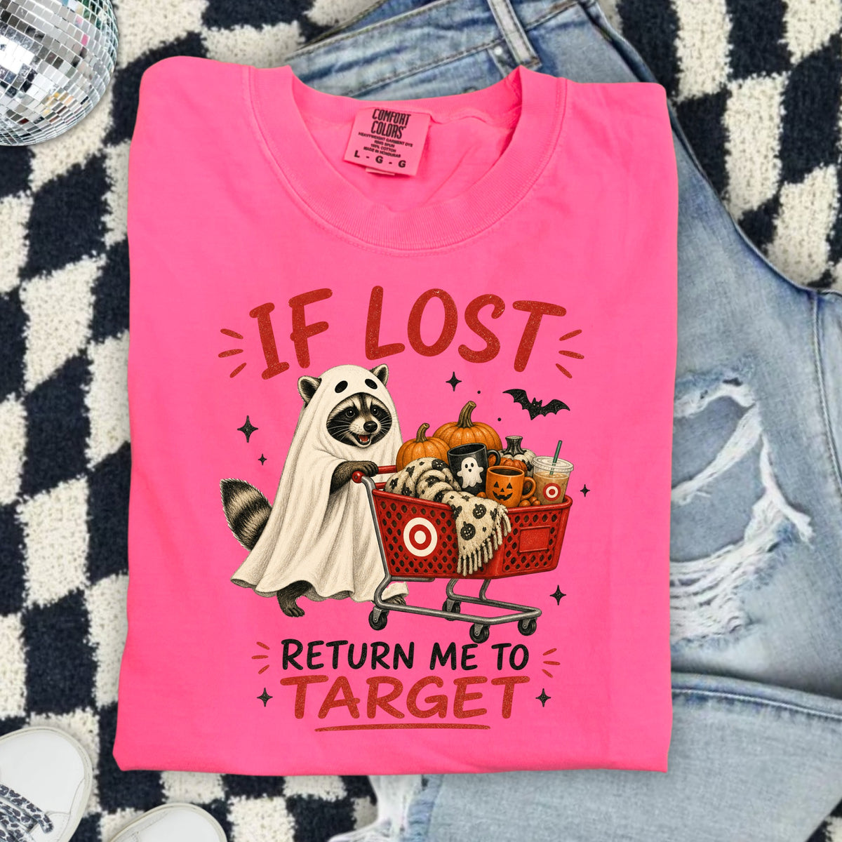 Neon pink t-shirt with raccoon ghost pushing a shopping cart and text "If Lost Return Me To Target".