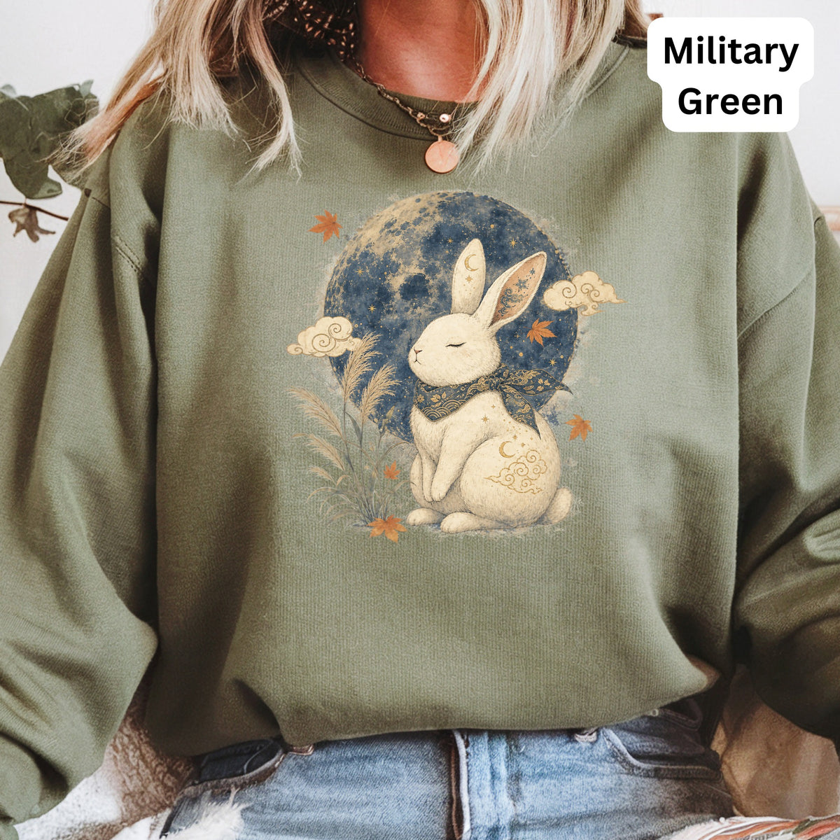 Crewneck sweatshirt with a graphic of a rabbit by the moon, in military green.