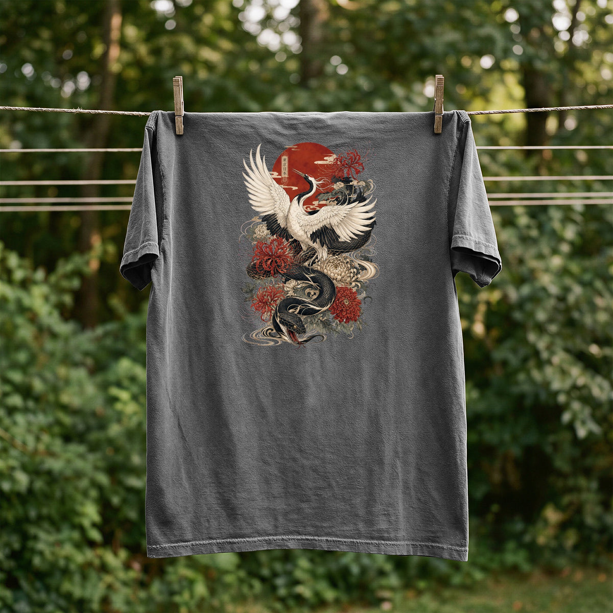 Grey t-shirt with a Japanese dragon and crane graphic, drying on a clothesline.