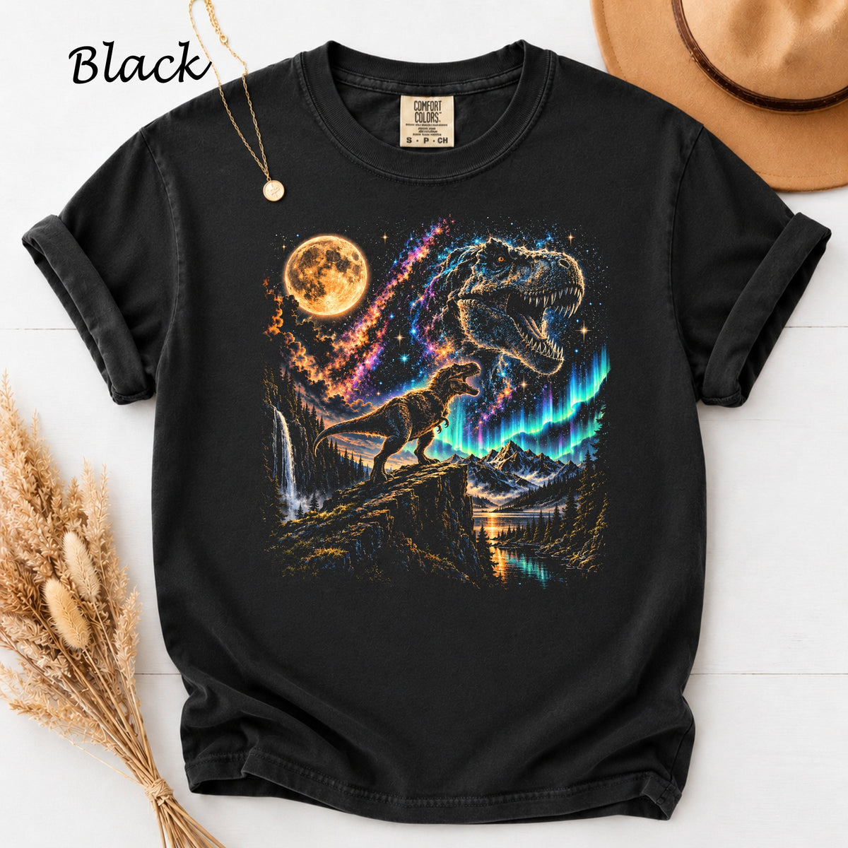 Black t-shirt with a T-Rex roaring under a full moon and aurora borealis.