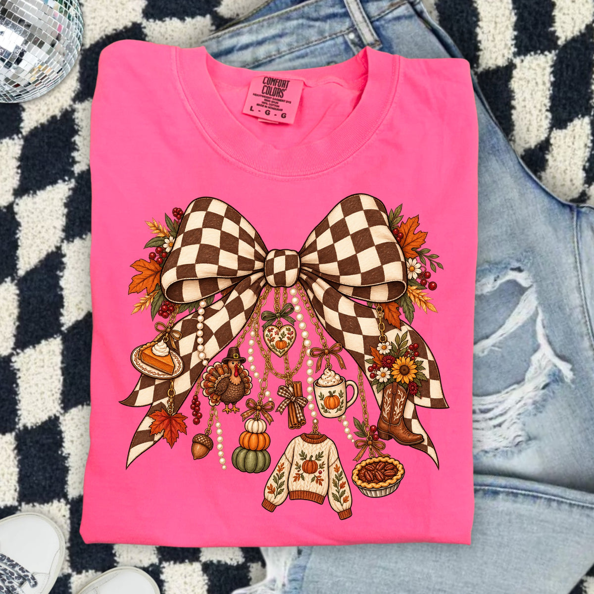 Pink shirt with checkered bow and fall harvest charms.
