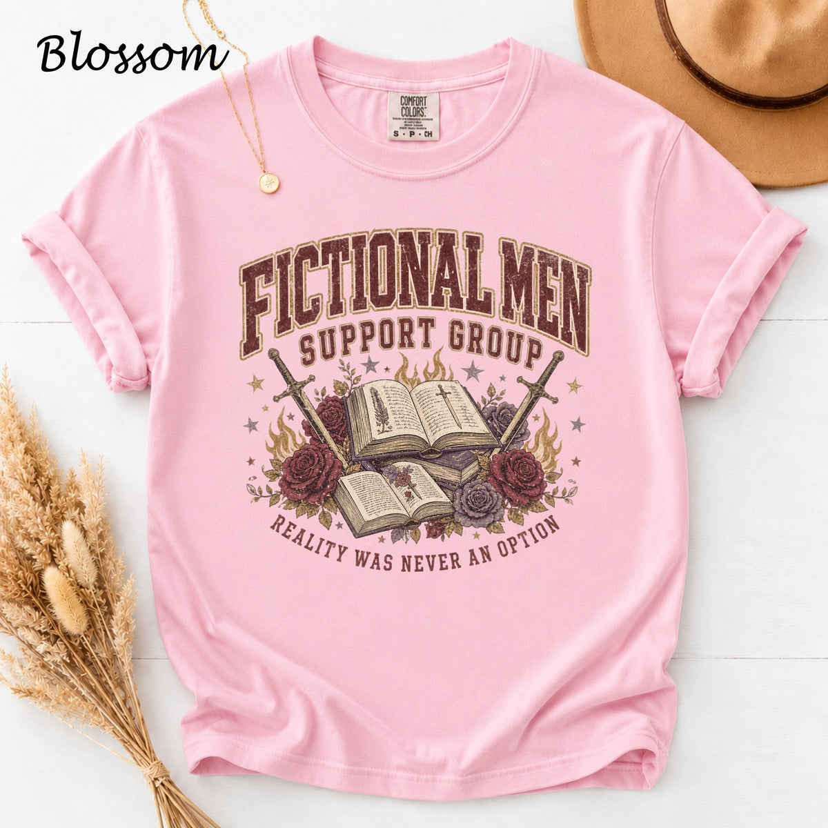 Pink t-shirt with "Fictional Men Support Group" and "Reality Was Never An Option" text.