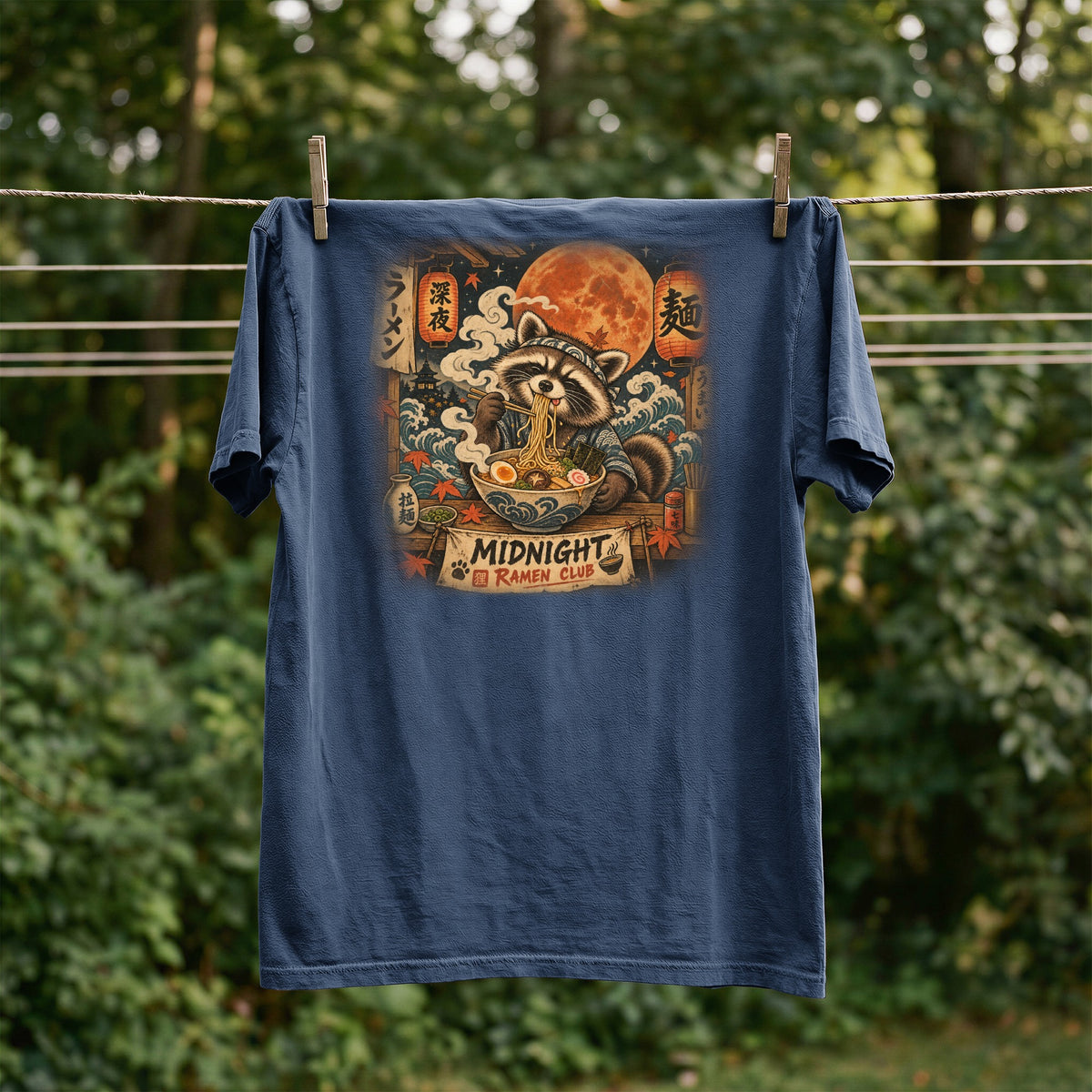 T-shirt with a raccoon eating ramen under a full moon, "Midnight Ramen Club" text.
