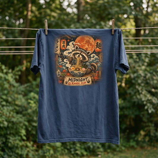 T-shirt with a raccoon eating ramen under a full moon, "Midnight Ramen Club" text.