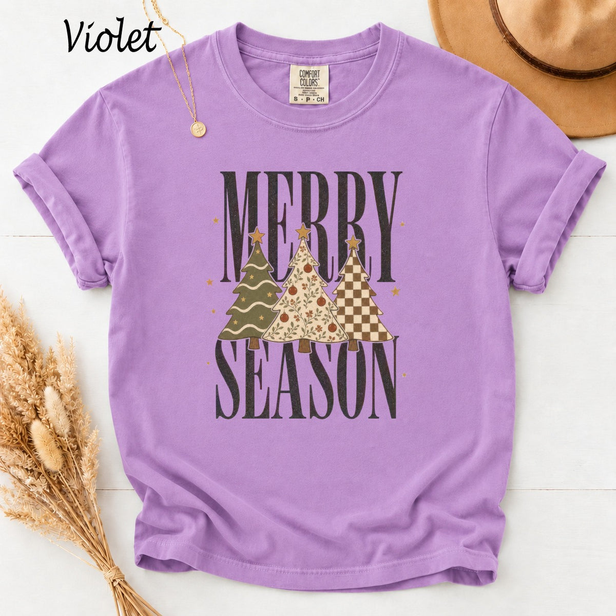 Purple t-shirt with "Merry Season" and three decorated Christmas trees graphic.