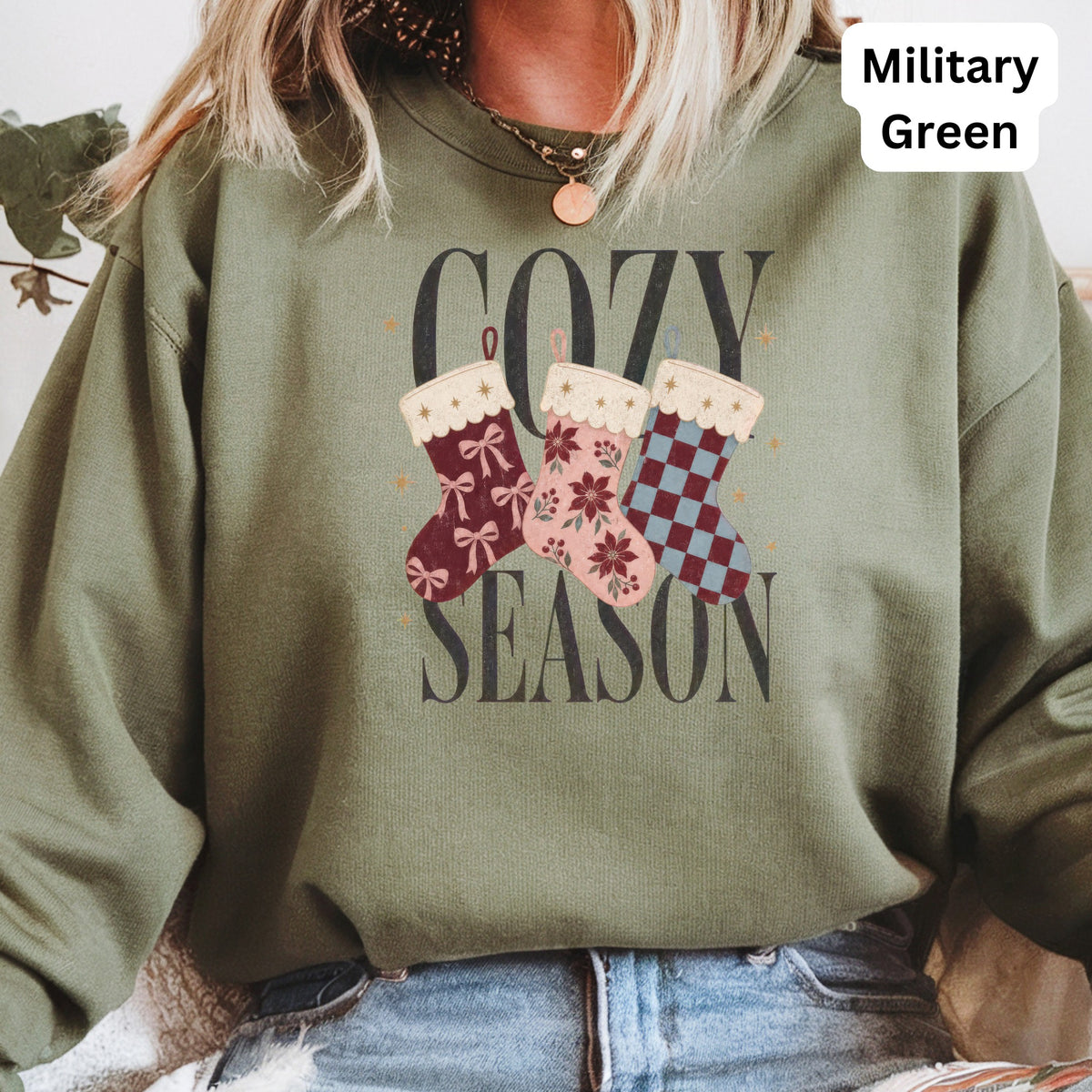 Green sweatshirt with "Cozy Season" text and three Christmas stockings.