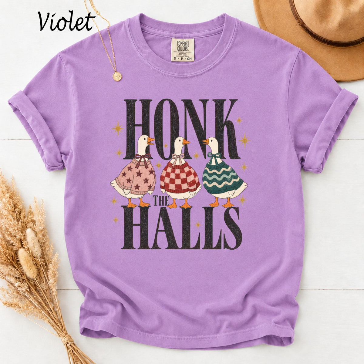 Purple t-shirt with three ducks wearing sweaters and the text "HONK THE HALLS".
