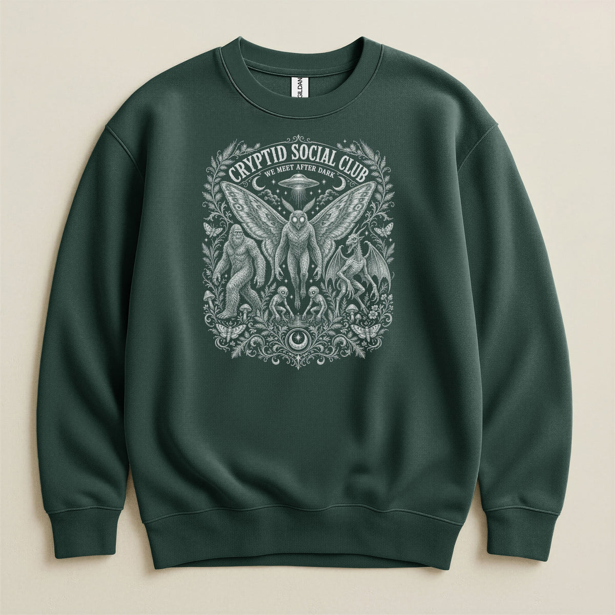 Dark green sweatshirt with "Cryptid Social Club We Meet After Dark" graphic.
