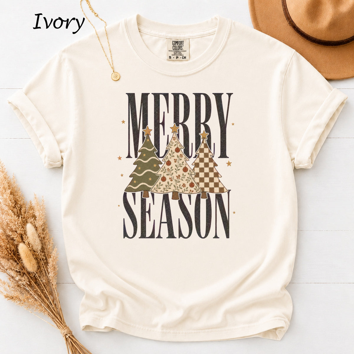 Cream t-shirt with "Merry Season" text and three decorated Christmas trees.