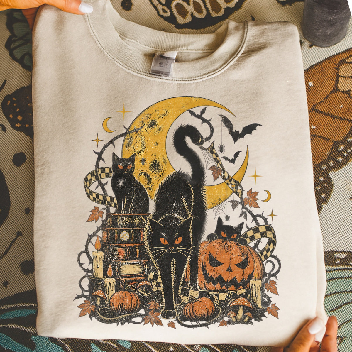 Halloween graphic with black cats, pumpkin, moon, bats, and candles.