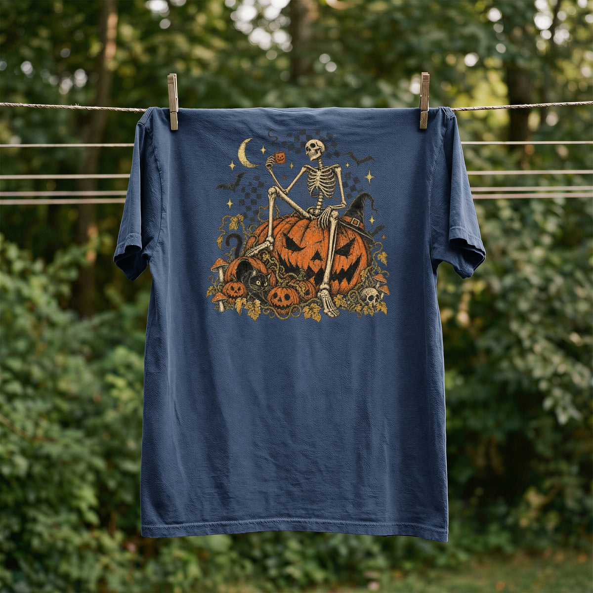 Navy t-shirt with Halloween skeleton, pumpkin, black cat, and moon graphic.