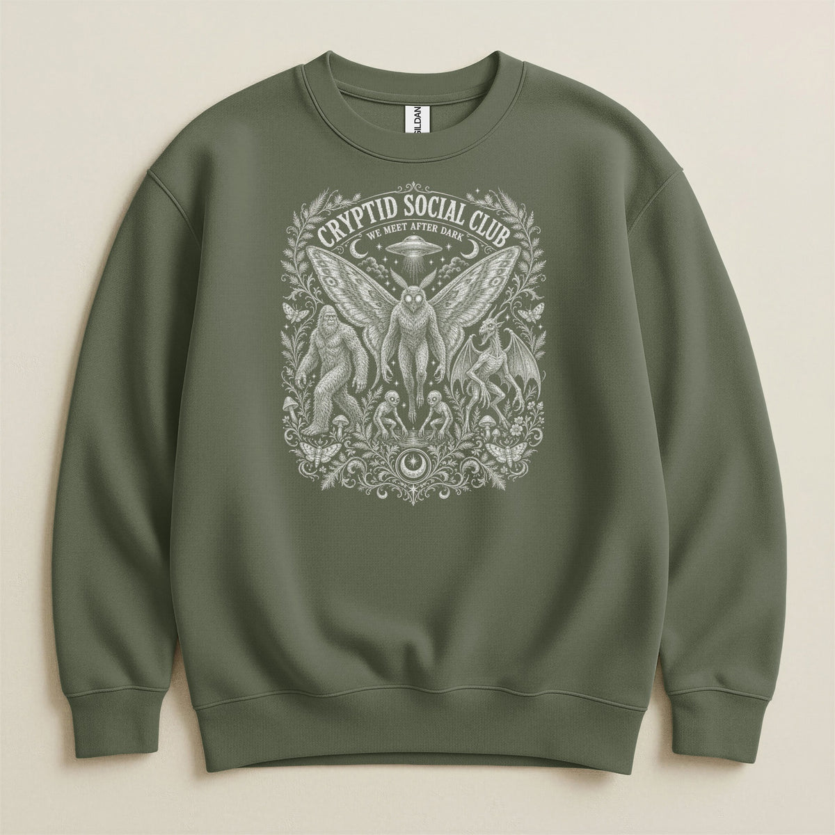 Green sweatshirt with "Cryptid Social Club We Meet After Dark" graphic.