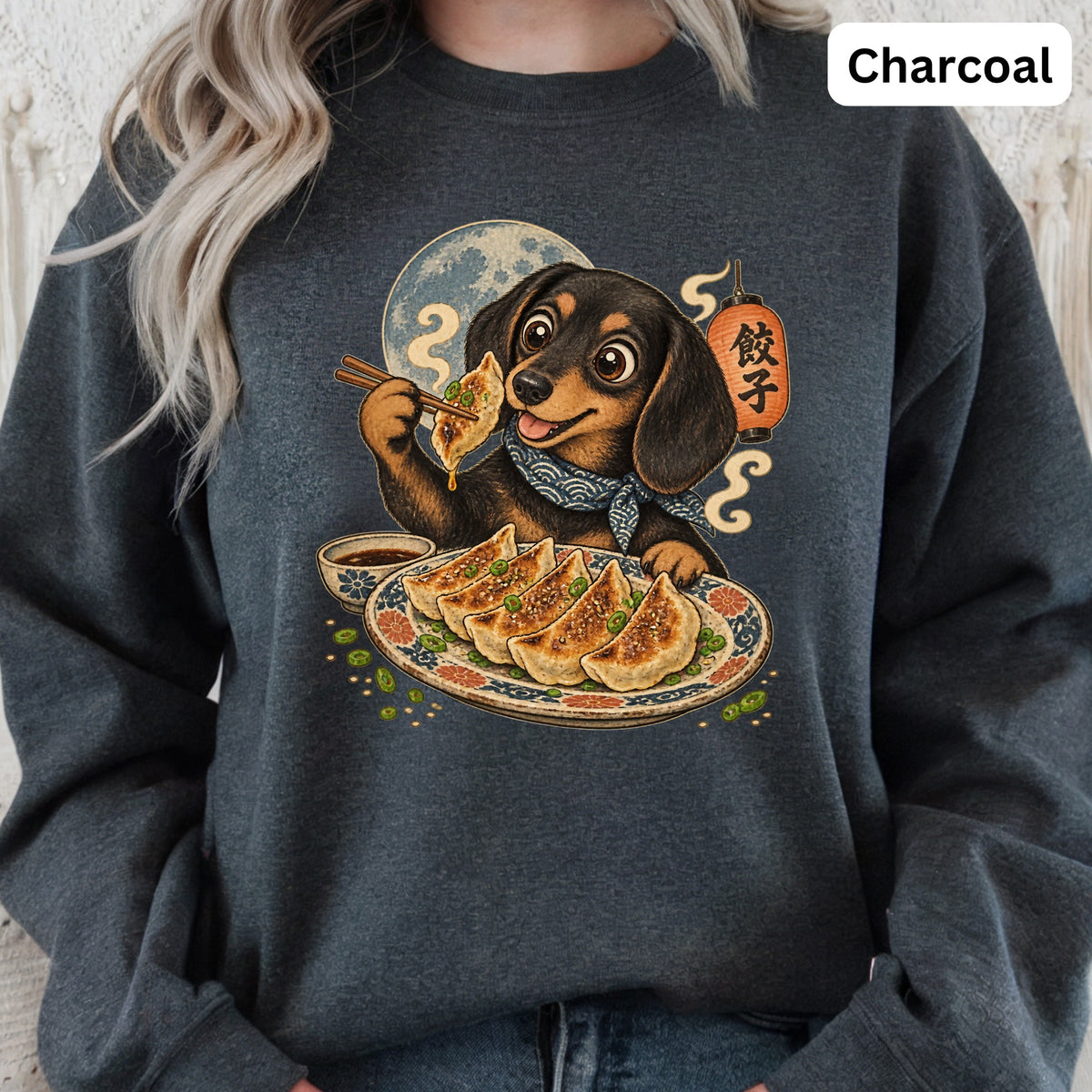 Dachshund eating dumplings with chopsticks, Japanese lantern, and full moon on charcoal sweatshirt.