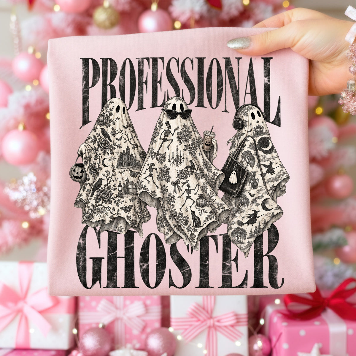 Three ghosts with intricate black and white patterns are shown on a pink shirt.