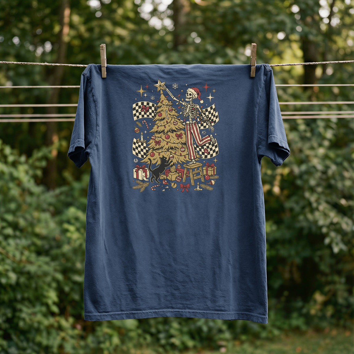 Navy t-shirt with skeleton and Christmas tree graphic featuring racing flags and presents.