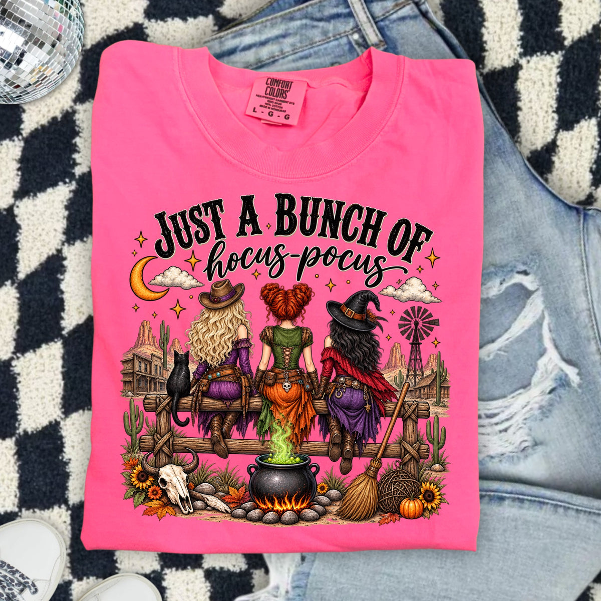 Pink t-shirt with "Just a Bunch of Hocus-Pocus" text and witches on a fence.