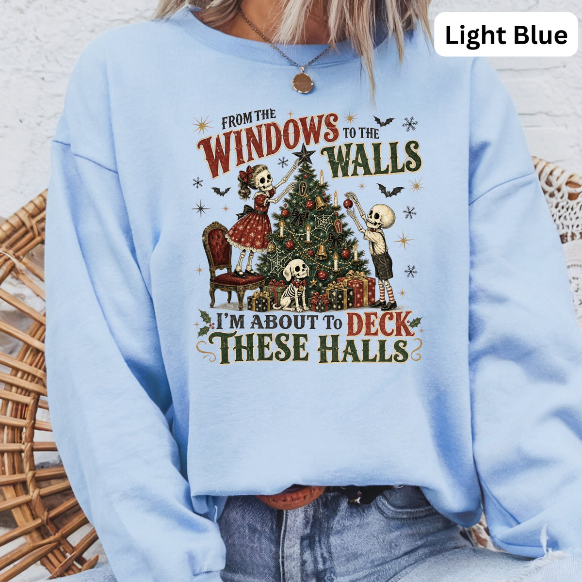Skeleton figures decorate a Christmas tree with the text "From the windows to the walls I'm about to deck these halls."
