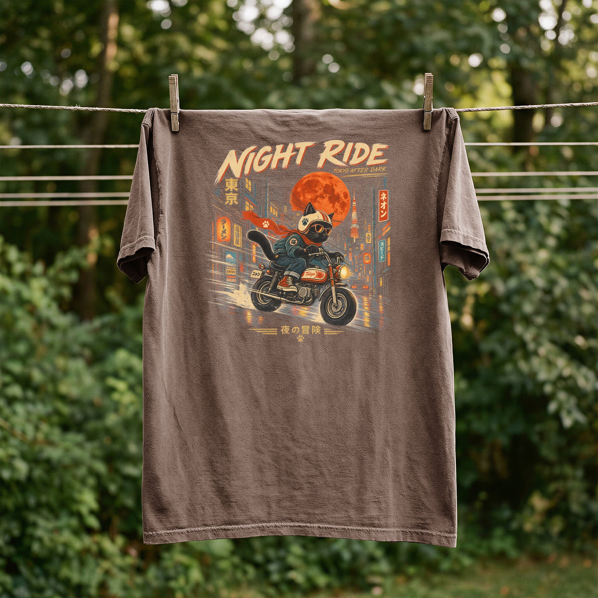 T-shirt with a cat riding a motorcycle in Tokyo at night, text "Night Ride" and Japanese characters.