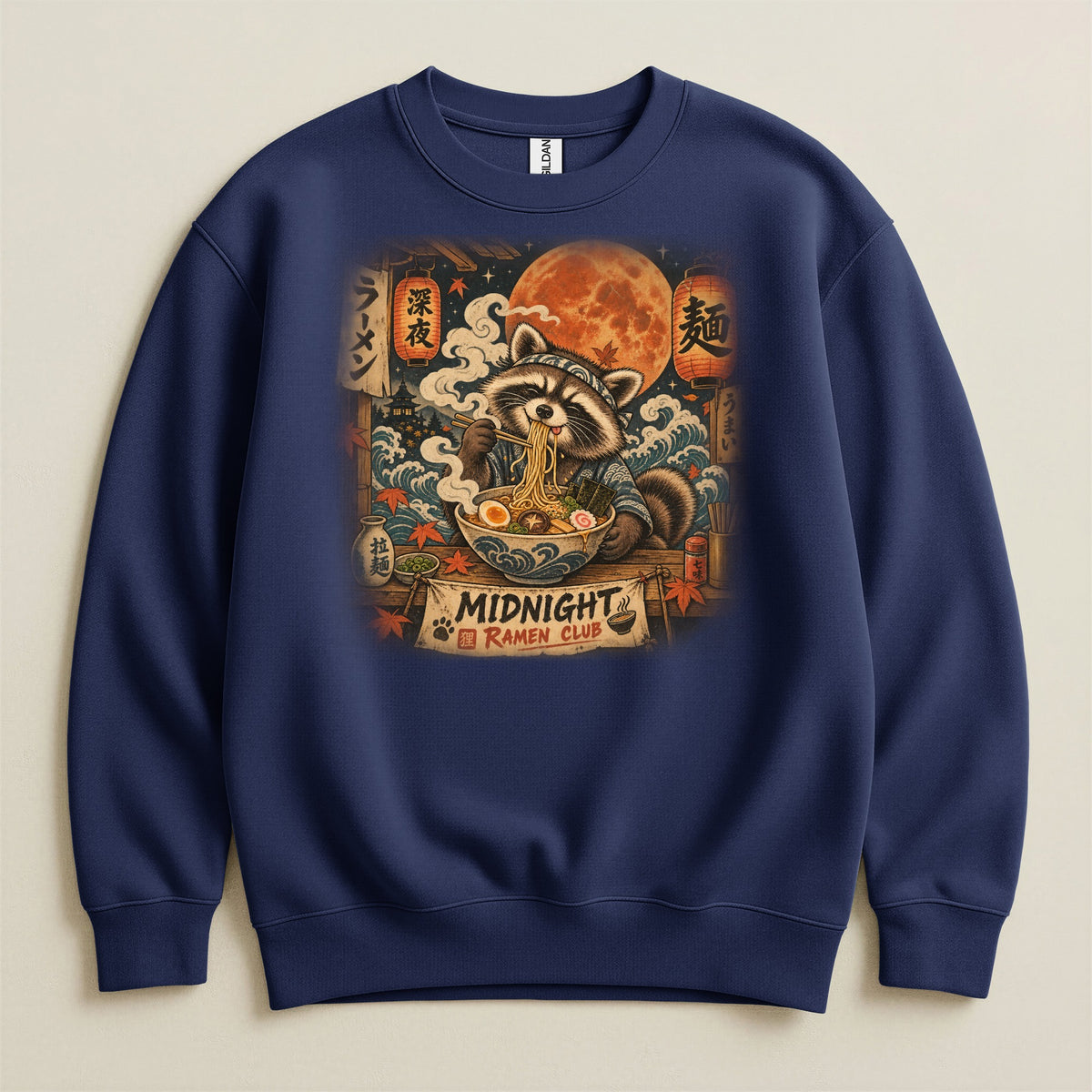 Navy sweatshirt with a raccoon eating ramen under a full moon, "Midnight Ramen Club" text.
