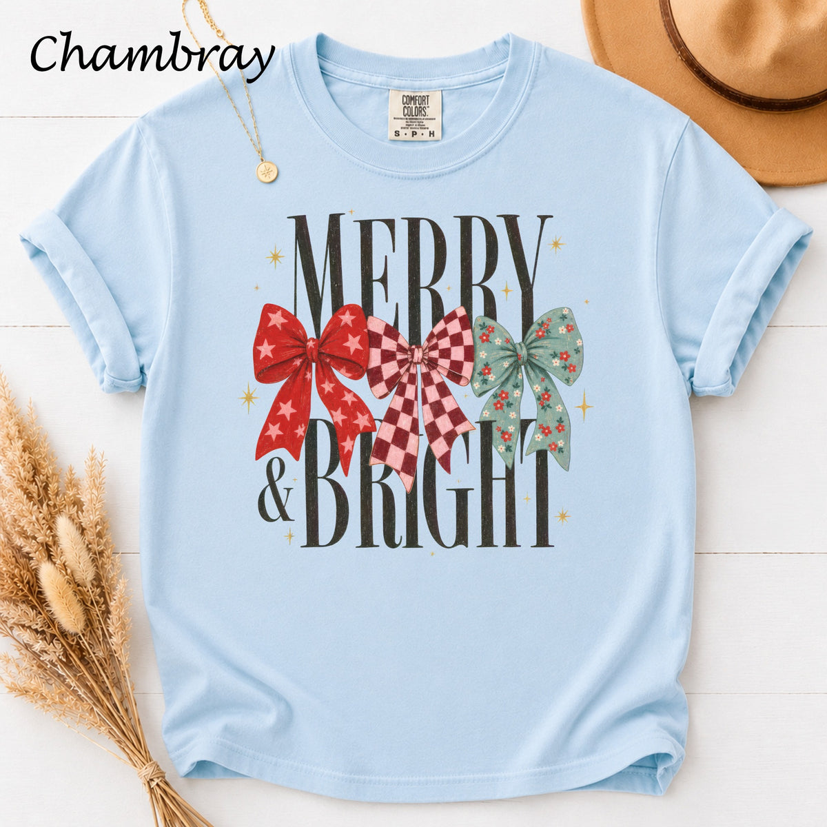 Light blue t-shirt with "Merry & Bright" text and three decorative bows.