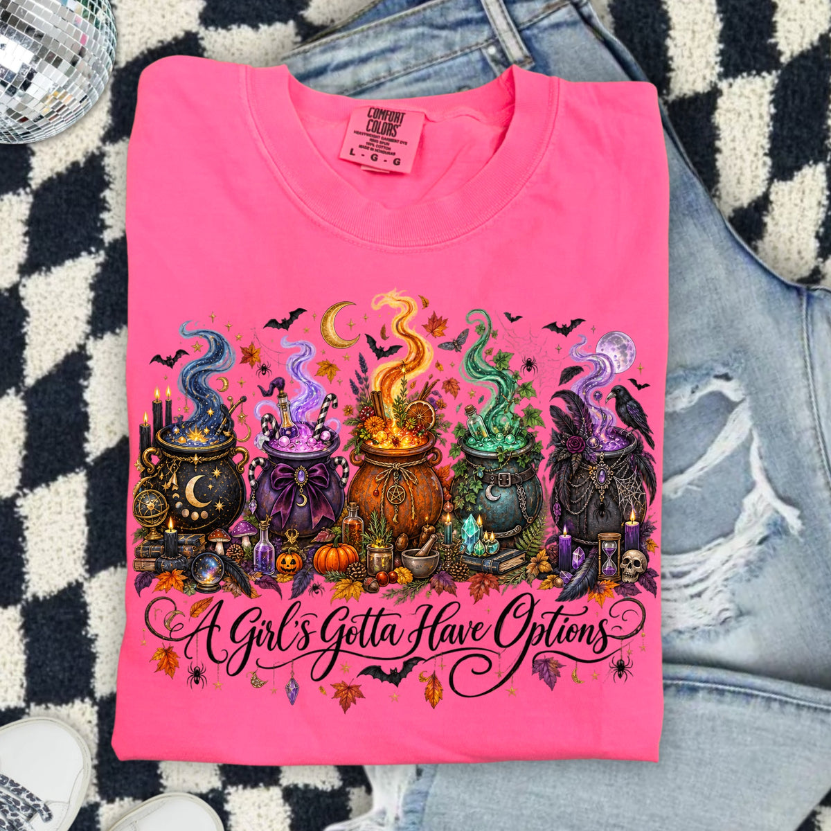 Pink Comfort Colors shirt with witchy cauldrons and "A Girl's Gotta Have Options" text.