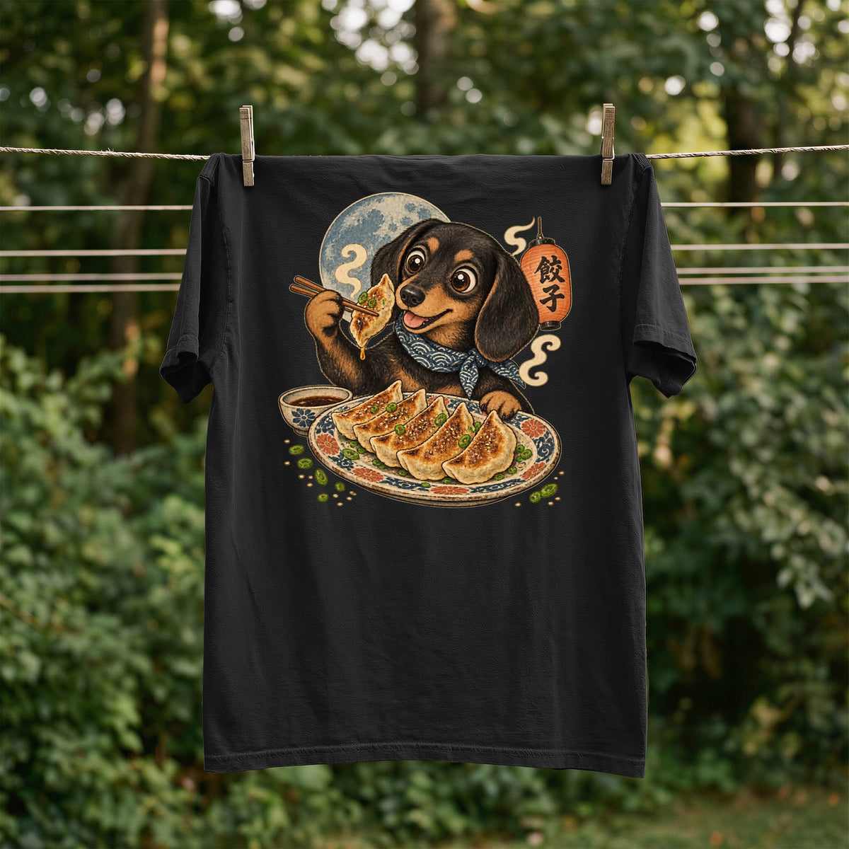 Black t-shirt with a dachshund holding gyoza, with a full moon and lantern graphic.