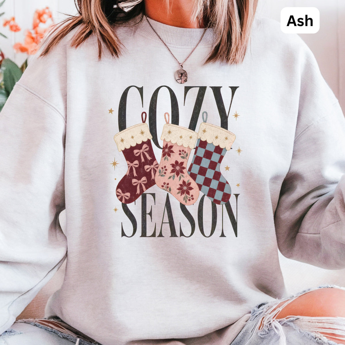 Ash gray sweatshirt with "COZY SEASON" text and three festive Christmas stockings.