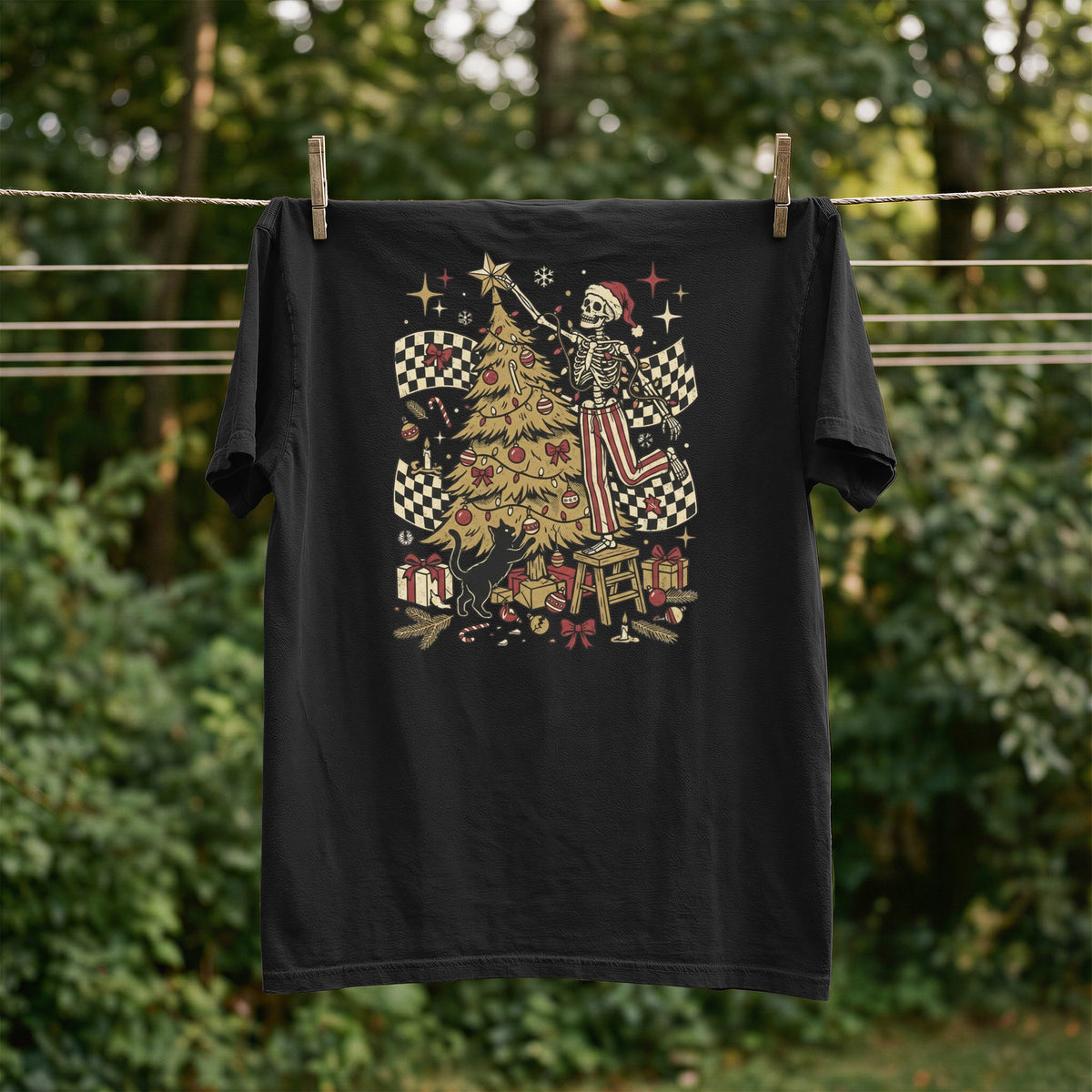 Black t-shirt with a skeleton decorating a Christmas tree with checkered flags.