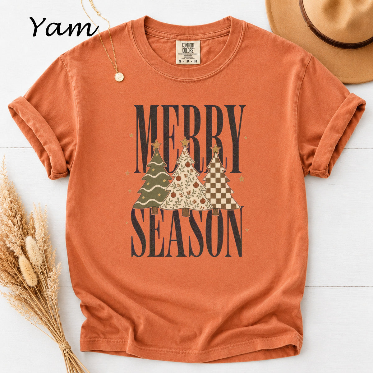 Orange t-shirt with "Merry Season" text and three decorated Christmas trees.