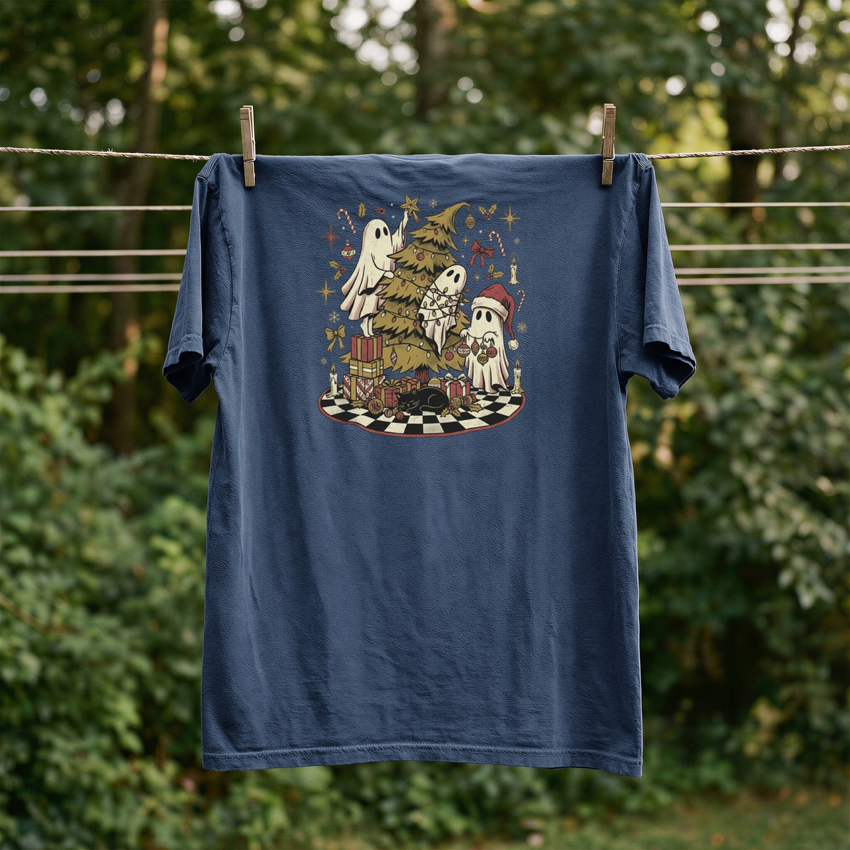 T-shirt with ghosts decorating a Christmas tree and a sleeping cat.