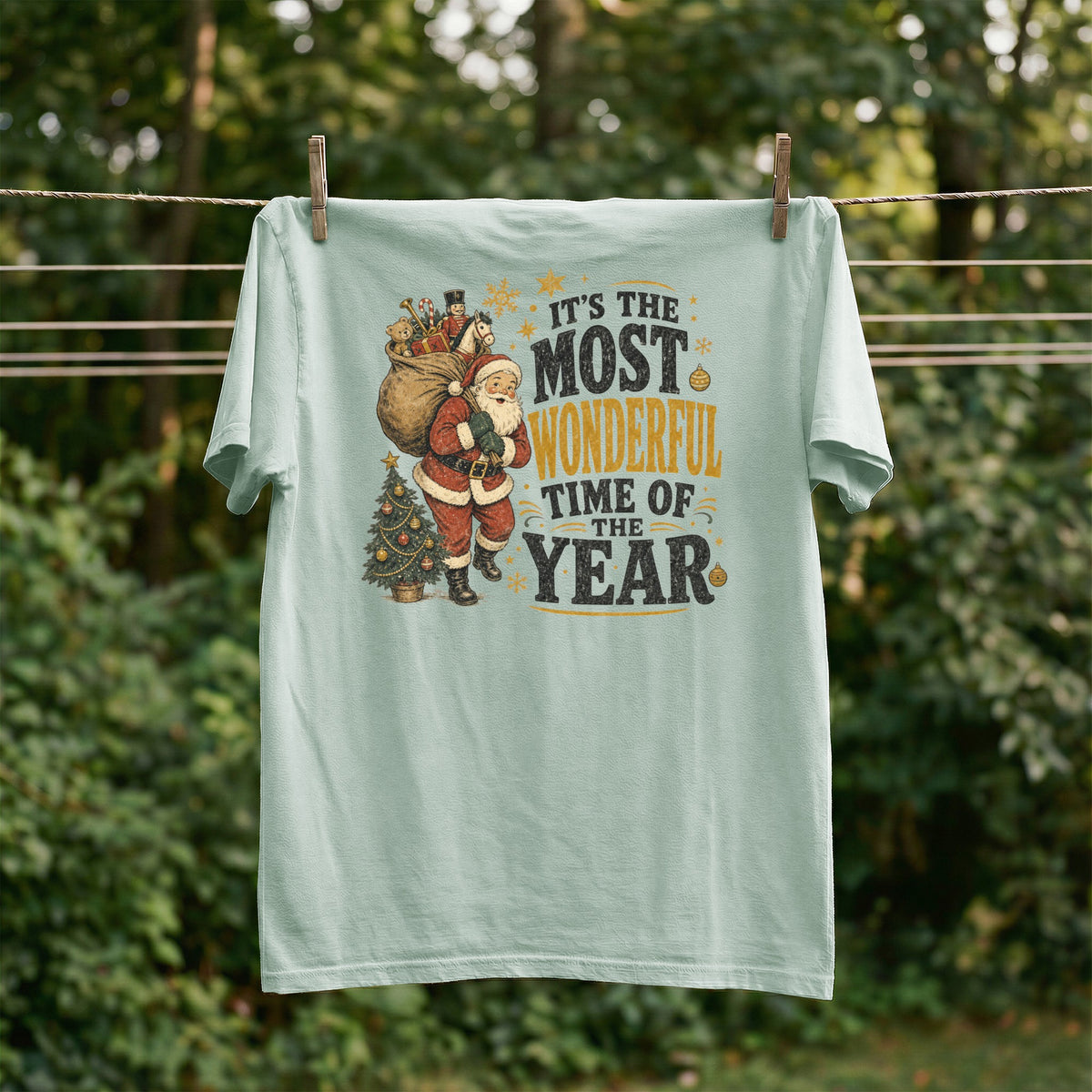 Light green t-shirt with Santa, Christmas tree, and "It's The Most Wonderful Time Of The Year" text.