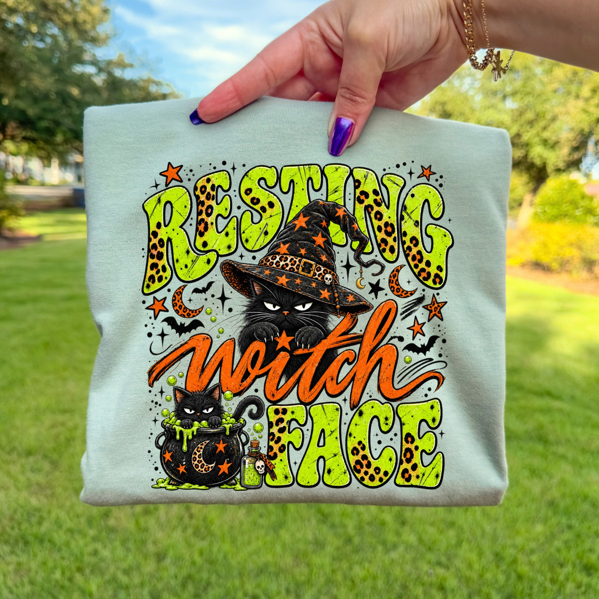 Black cat graphic on a t-shirt with text "Resting Witch Face"
