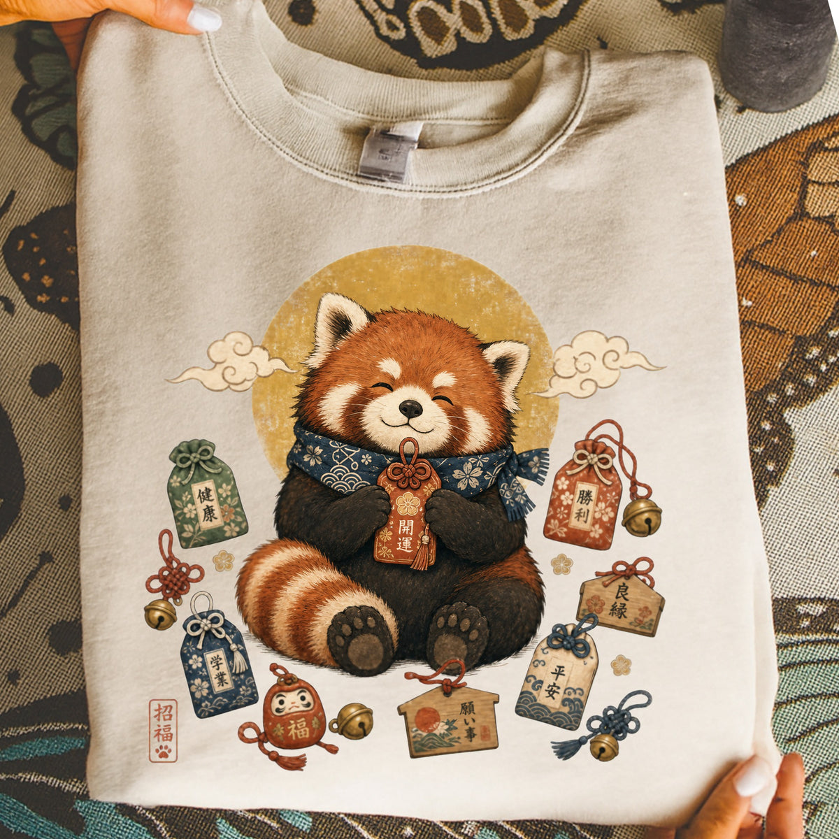 Red panda wearing scarf surrounded by Japanese good luck charms and symbols.