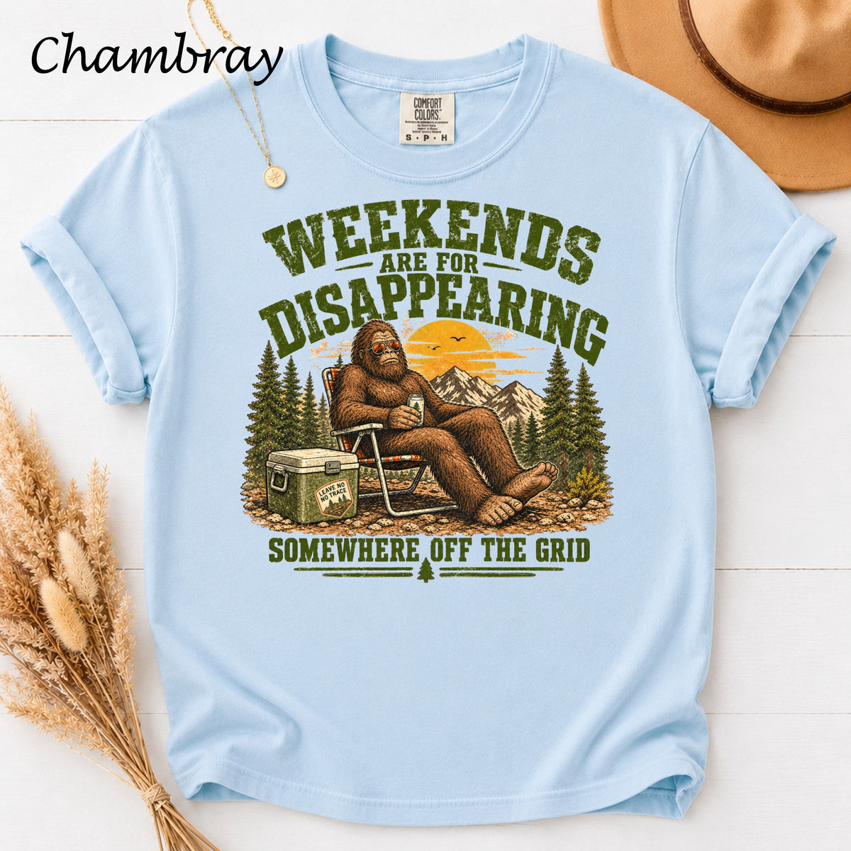 Bigfoot relaxing in a chair with a cooler, text "Weekends Are For Disappearing Somewhere Off The Grid".