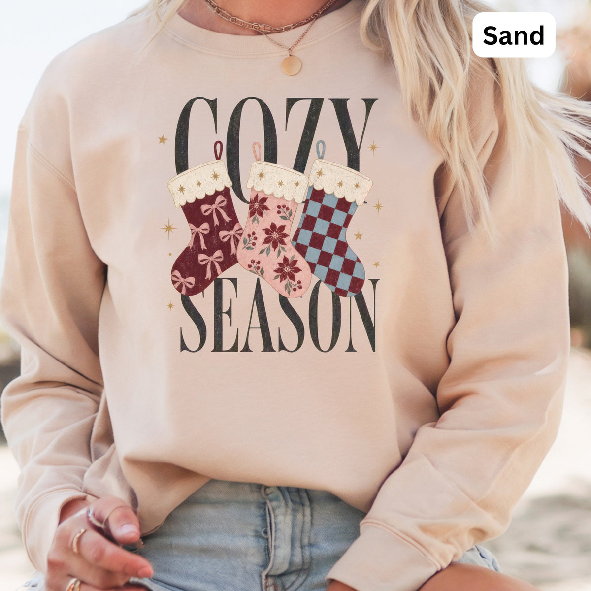 Crewneck sweatshirt with "Cozy Season" graphic and festive stockings.