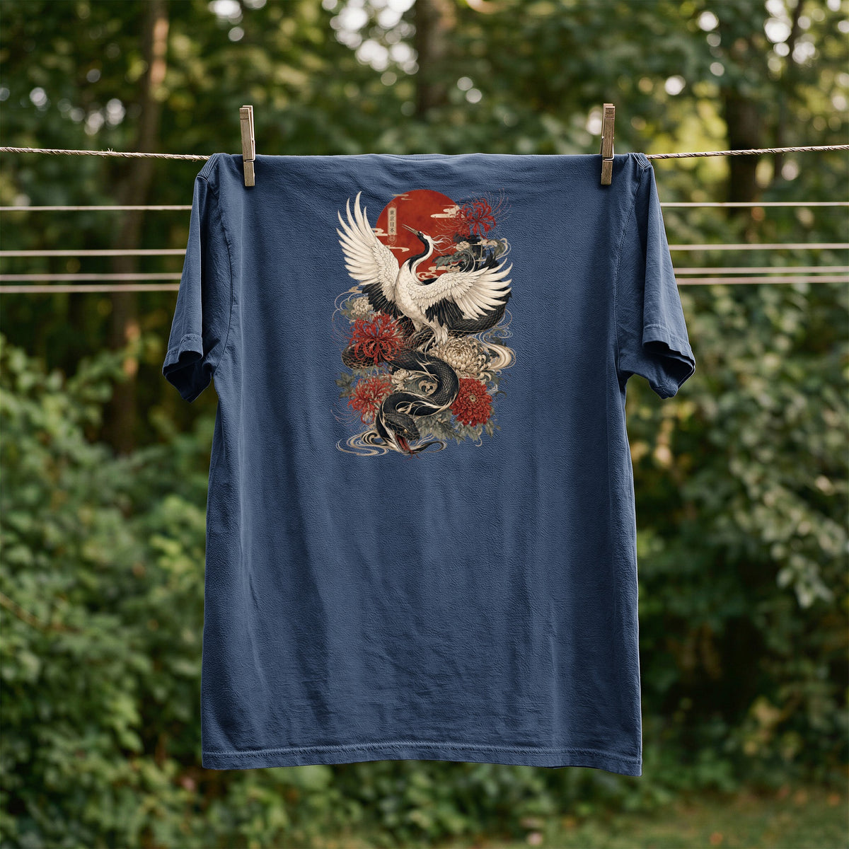 Dark blue t-shirt with Japanese crane and dragon graphic, hung on a clothesline.