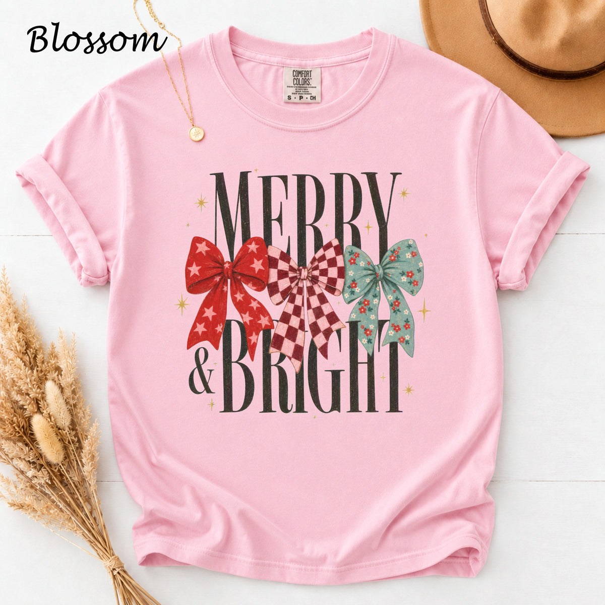 Pink t-shirt with "Merry & Bright" text and three decorative bows.