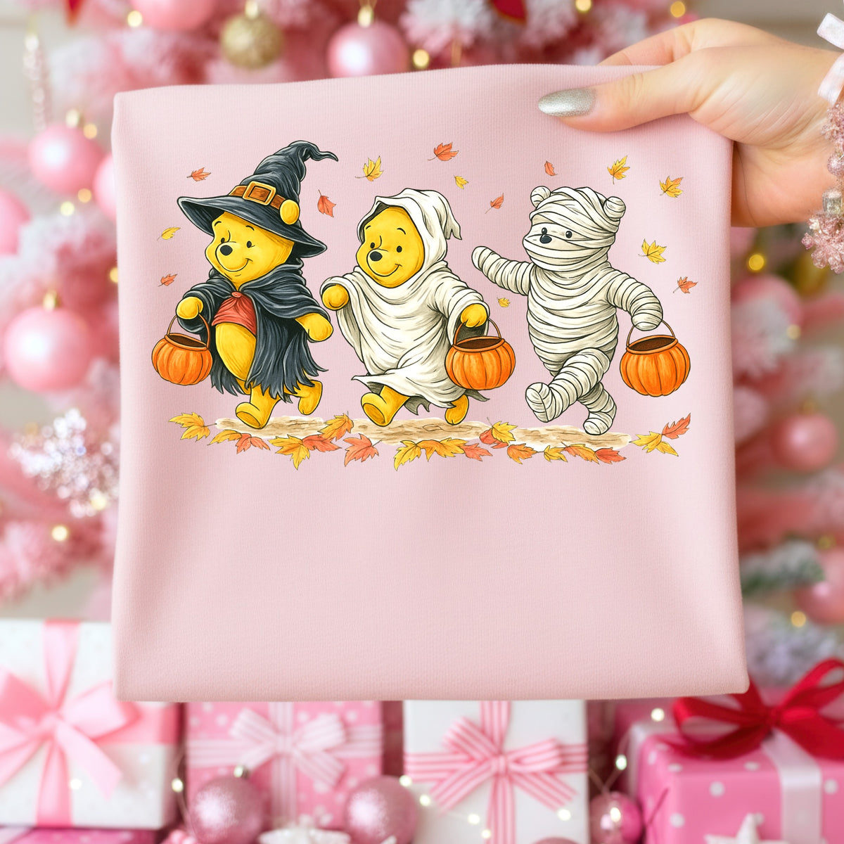 Winnie the Pooh characters dressed as a witch, ghost, and mummy carry pumpkin buckets.