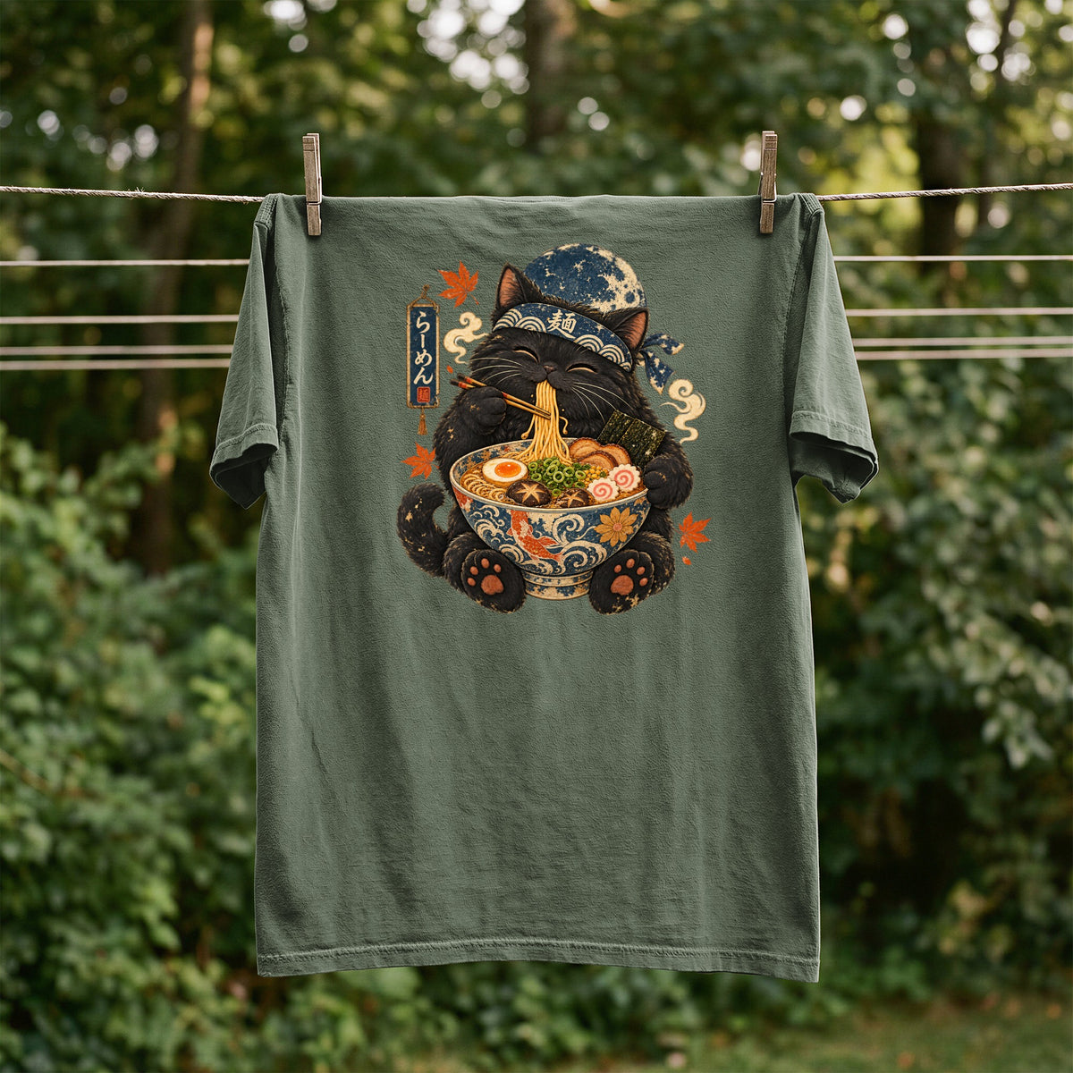 Black cat wearing a bandana eats ramen from a bowl, with Japanese text.